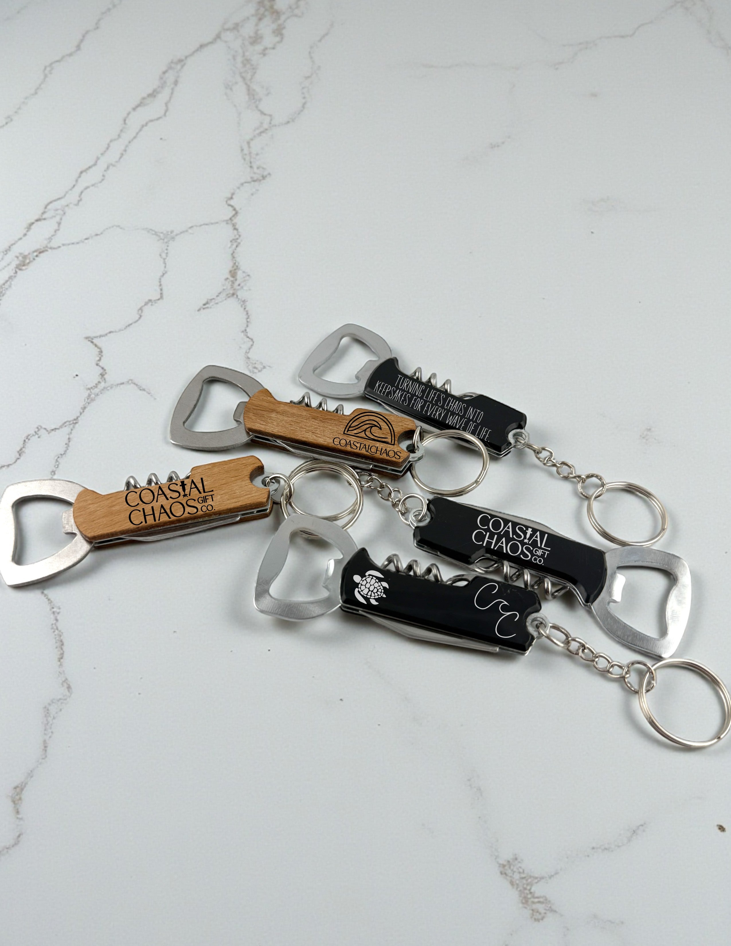 Coastal Chaos Co. custom engraved wood and black multi-tool corkscrew bottle openers with keychains.