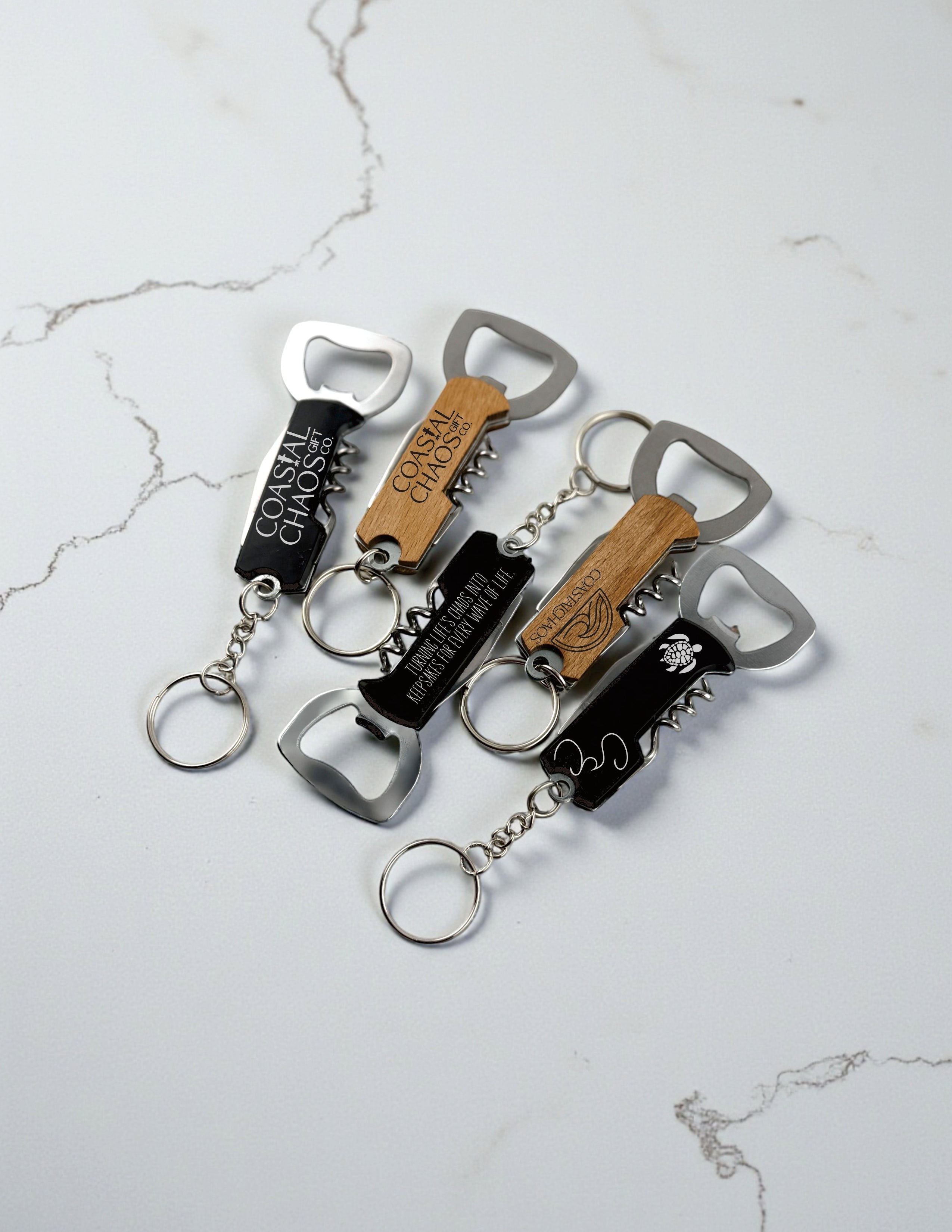 Coastal Chaos Co. custom engraved corkscrew bottle opener keychains in black and wood finishes. Features include a bottle opener and corkscrew.