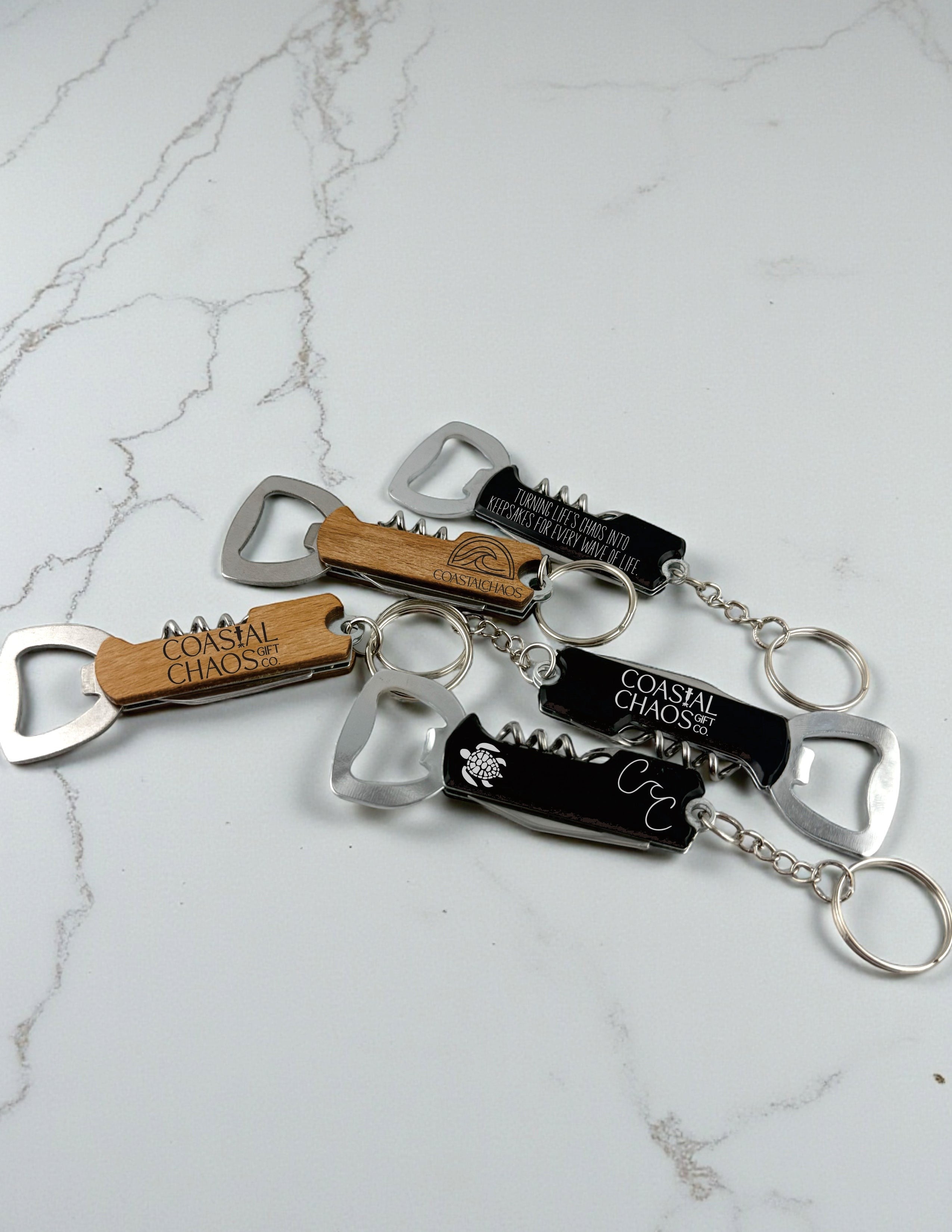 Coastal Chaos Co. wood and black multi-tool keychains with corkscrew and bottle opener functions.