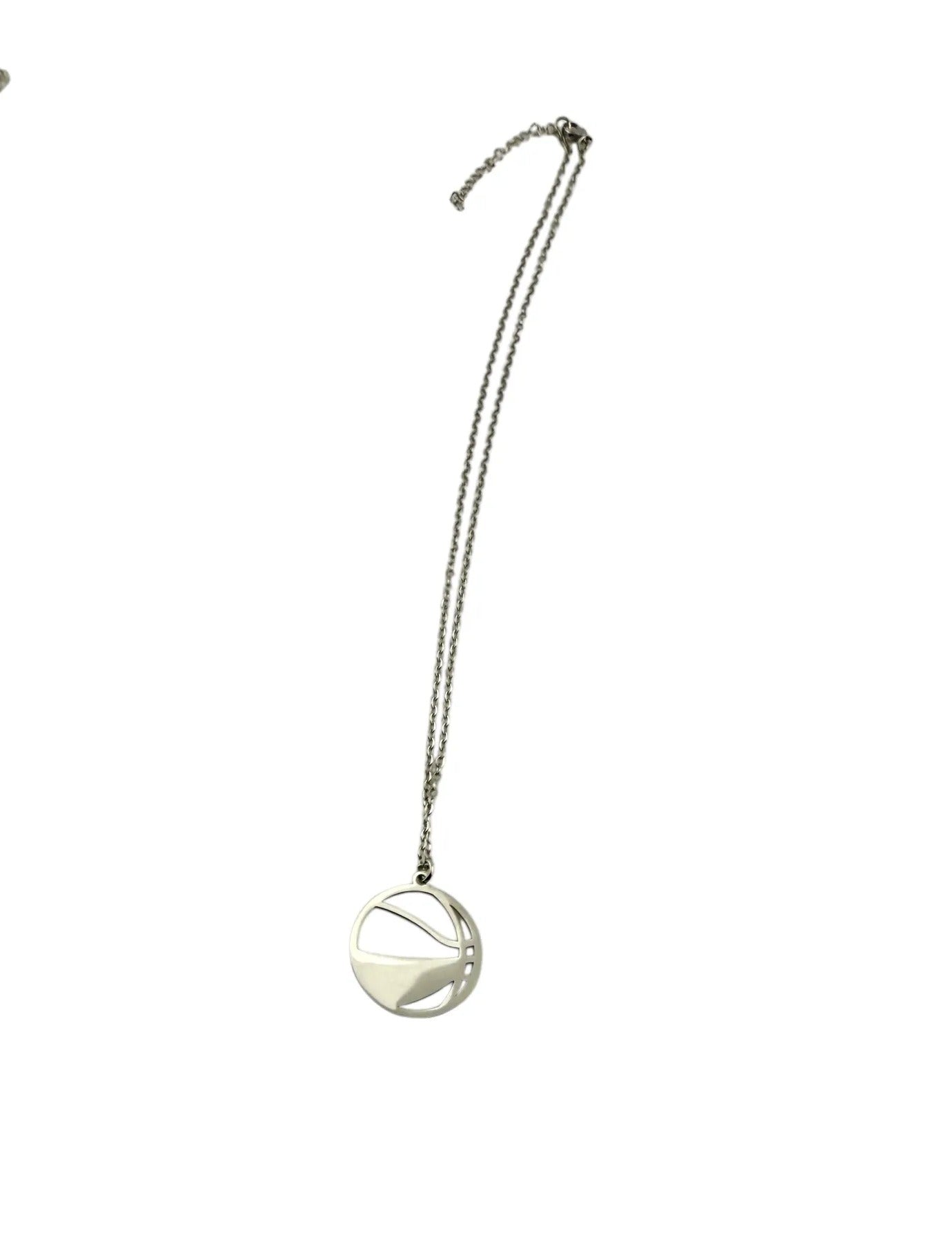 A silver necklace with a round pendant is shown against a white background.