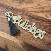 A keychain with the word "Bulletproofs" written on it, resting on a wooden surface.