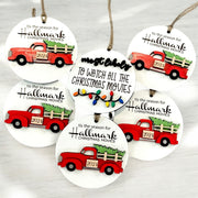 A collection of five ornaments shaped like a red truck, each with a Christmas tree and the text "Tis the season for Hallmark Christmas movies" printed on them.