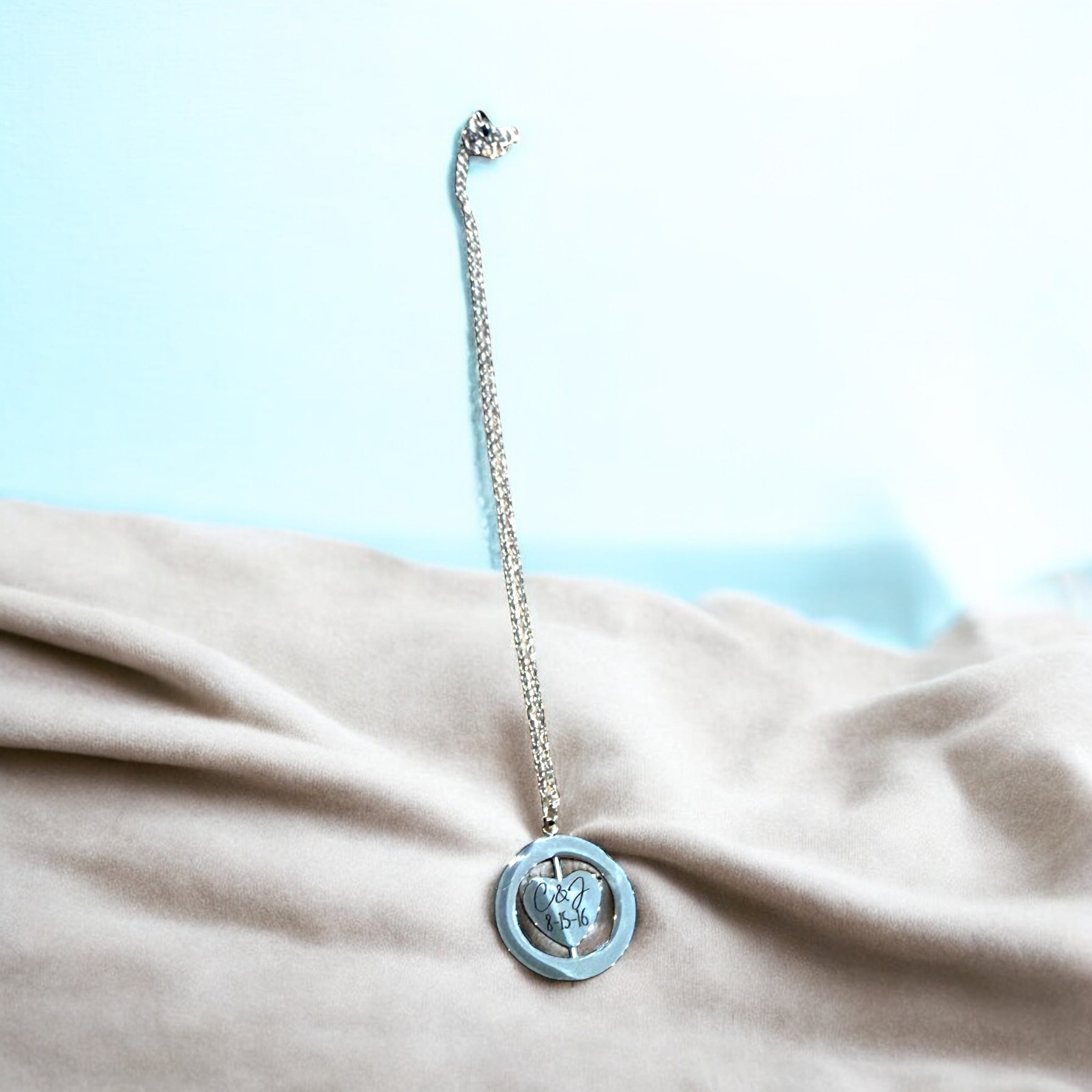 Necklace with a blue pendant on a beige fabric background