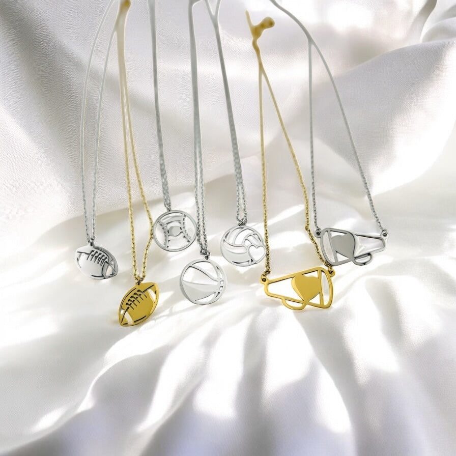 Necklaces with various pendants on a white fabric background