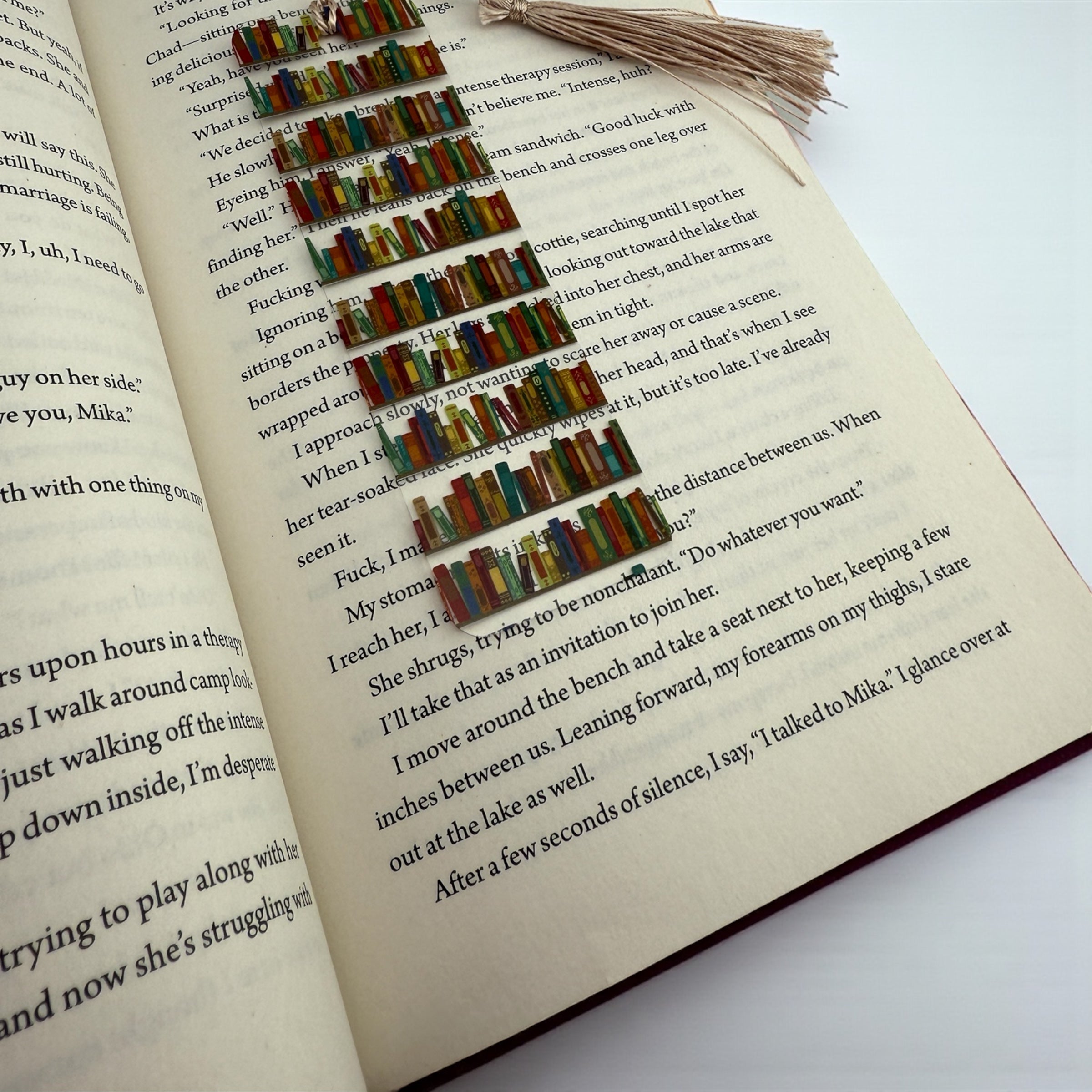 a close-up view of an open book with colorful bookmarks arranged in a row on the right page.