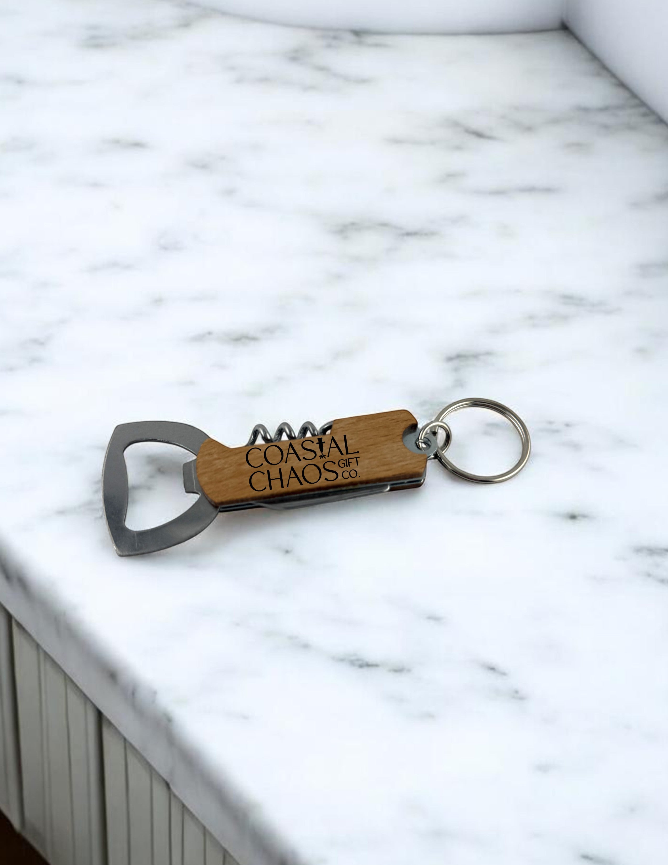 Coastal Chaos Co. engraved wood and metal multi-tool keychain with corkscrew and bottle opener.