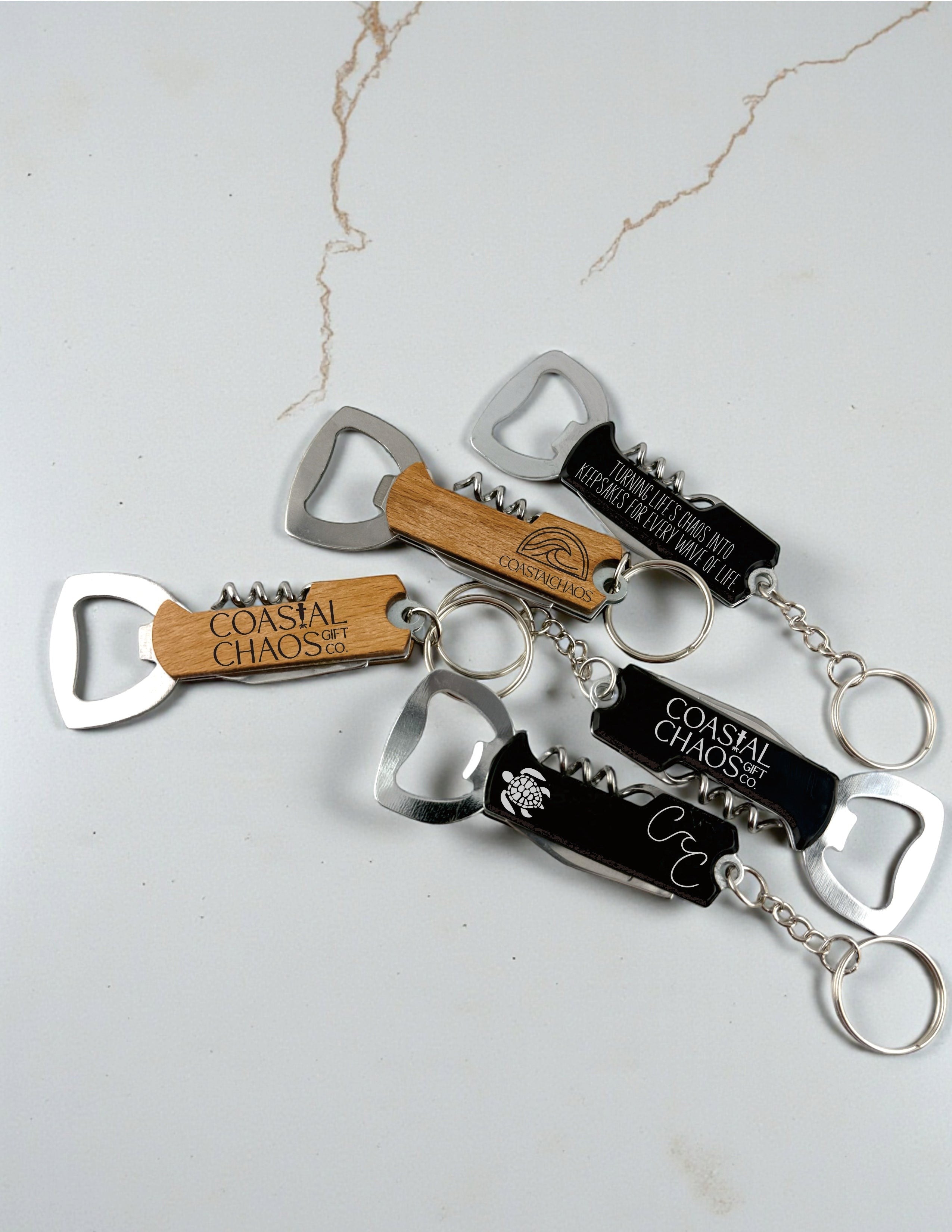 Coastal Chaos Co. custom engraved corkscrew bottle opener keychains in wood and black finishes with metal multi-tools.