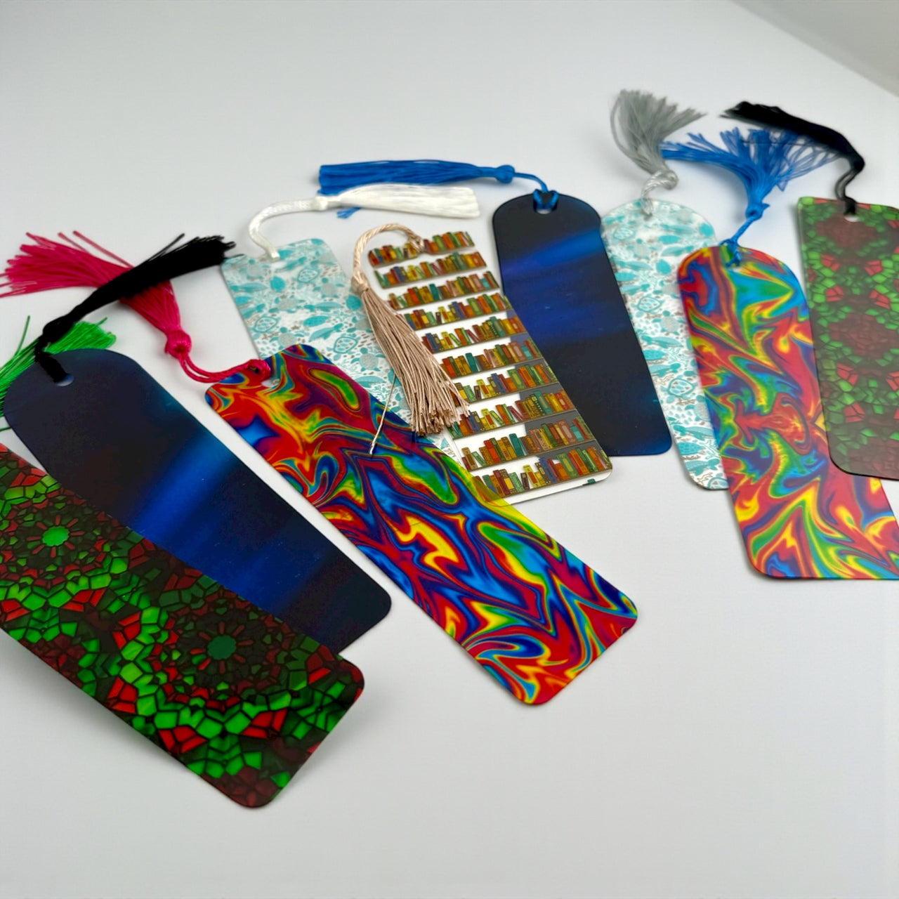 A collection of colorful, patterned bookmarks with various designs, including stripes, swirls, and geometric patterns, arranged on a white background.